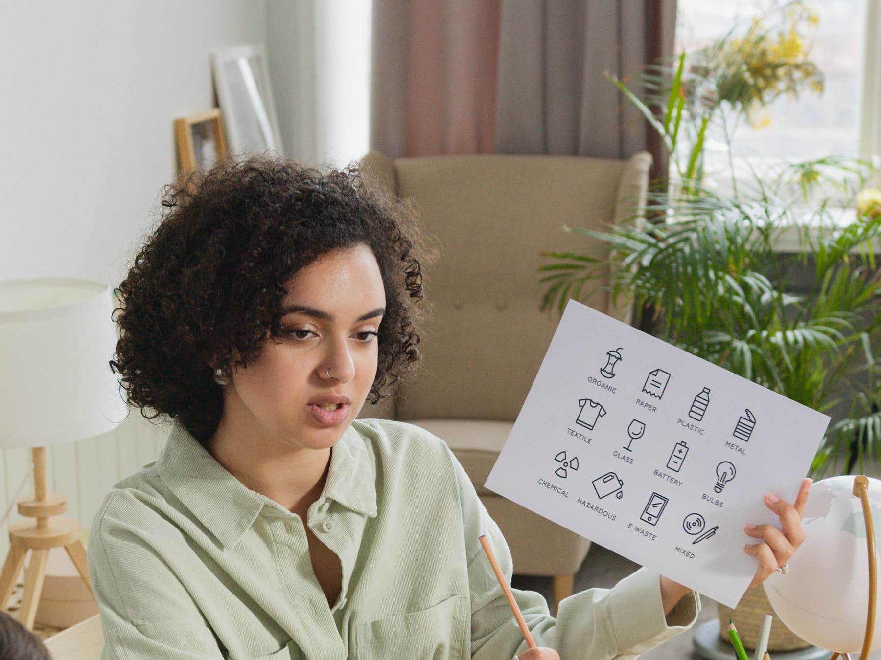 A woman working through a practice sheet at a table at home.